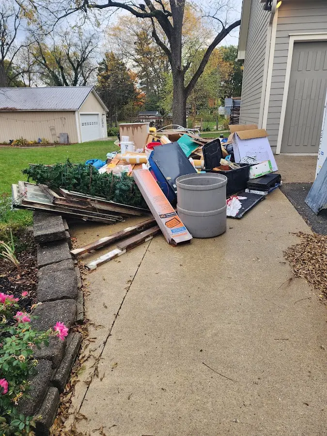 Dumpster being loaded with debris for Estate Cleanout Dumpster Rental in Ridgewood village